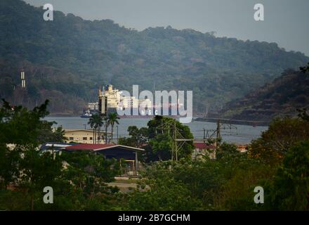 Cargo ship transiting Panama Canal with surrounding lush vegetation by Gamboa. Panama Stock Photo