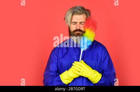 Feeling unhappy. hipster holding the cleaning tool. cleaning and home concept. man Sweeping with small duster broom. cleaning service. housekeeping business. Cleaning the apartment. man use pp duster. Stock Photo