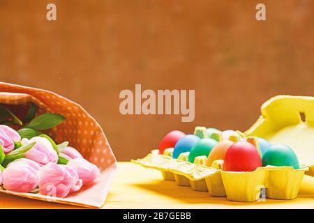 Tulip flower bouquet. Healthy and happy holiday. Spring holiday. Holiday celebration, preparation. Happy easter. painted eggs in egg tray. Egg hunt. copy space. Feeling joy about holiday. Stock Photo
