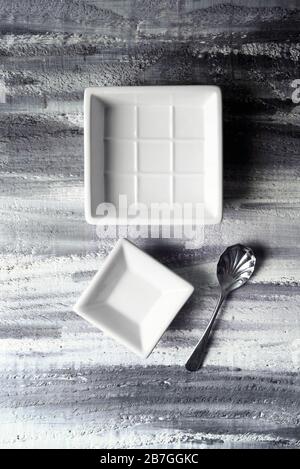White dishes on mono rustic background Stock Photo
