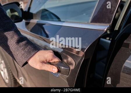 The man opened the door of the car. Close up. Stock Photo