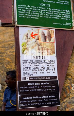 Asia Sri Lanka Sigiriya Rock sign signs warning bumble bees wasps no entry if they attack no refunds no graffiti writing on walls drunk Stock Photo