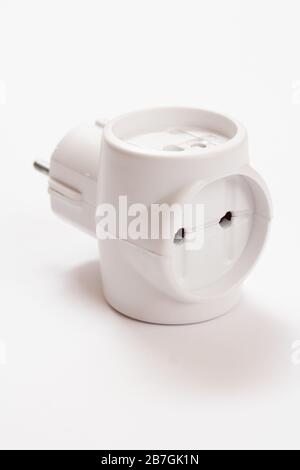 Plastic electrical tee connector with three sockets on a white background. Stock Photo