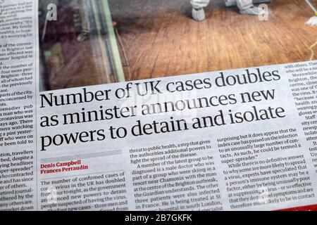 Guardian article inside page coronavirus article 'Number of UK cases doubles as minister announces new powers to detain and isolate' in 2020 London UK Stock Photo