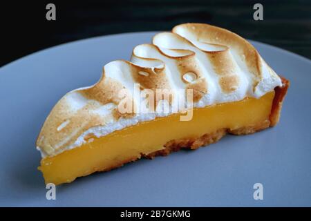 Closeup Tasty Lemon Meringue Tart on Blue Grey Plate Stock Photo