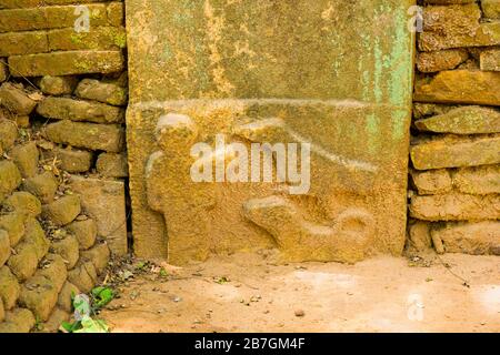 Asia Sri Lanka Polonnaruwa ancient sculptures on stone detail bas-relief human figure man dogs brick wall some 2000 years old Stock Photo
