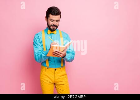 Portrait of his he nice attractive confident focused cheerful cheery bearded guy wearing mint shirt writing thoughts planning strategy isolated on Stock Photo