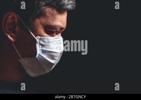 Profile of man in mask, concept of viral infection. Theme of corona-virus epidemic. Stock Photo