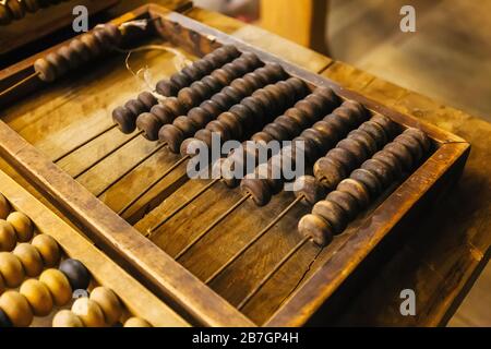 Old vintage wooden abacus on wooden table. Stock Photo