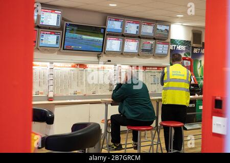 Edinburgh, Scotland, UK. 16 March, 2020. Effects of Coronavirus in Edinburgh City Centre today. Ladbrokes betting shop very quiet with punters watching horse racing on TV. Race meetings today are being held behind closed doors until the end of March at the earliest. Iain Masterton/ Alamy Live News Stock Photo