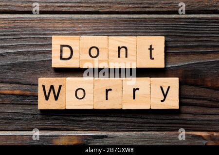 Don't worry word written on wood block. Don't worry text on wooden table for your desing, Top view concept. Stock Photo