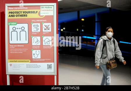 15 March 2020, Switzerland, Zürich: Signs at Zurich Airport illustrate how to act against the spread of the coronavirus (2019-nCoV). Photo: Britta Pedersen/dpa-Zentralbild/dpa Stock Photo