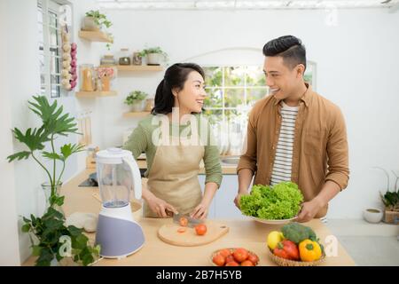 Attractive couple is cooking on kitchen. Stock Photo