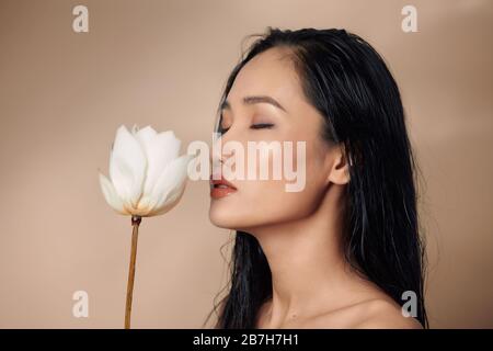 A beautiful young woman holding dried lotus buds Stock Photo