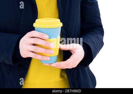 Hand holding stylish reusable eco coffee cup outdoors. Take away coffee Stock Photo