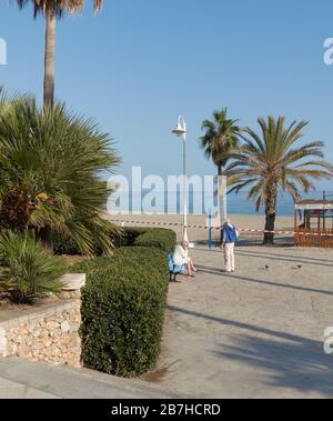 Worried Irish holidaymakers by a closed beach due to coronavirus social distancing measures, Nerja, Malaga, Spain Stock Photo