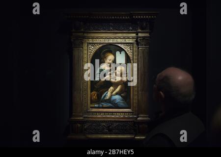 Visitor in front of the painting 'Benois Madonna' by Italian Renaissance painter Leonardo da Vinci (1478) displayed at his exhibition in the Louvre Museum in Paris, France. The exhibition marking the 500th anniversary of Leonardo's death runs till 24 February 2020. Stock Photo