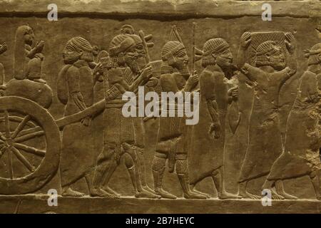Elamite prisoners campaign of King Ashurbanipal against Elam depicted in the Assyrian relief from the King Ashurbanipal Palace in Nineveh dated from 645 BC on display in the Louvre Museum in Paris, France. Stock Photo