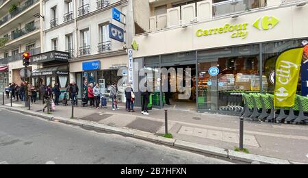 PARISIANS QUEUE FOR FOOD AT SUPERMARKET AFTER CORONAVIRUS OUTBREAK , PARIS  FRANCE Stock Photo