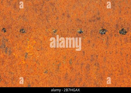 The surface of an old rusty abandoned sheet of iron with traces of welding spots. Modern trendy abstract rust texture background Stock Photo