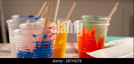 Artist acrylic colours in plastic cups in art studio Stock Photo