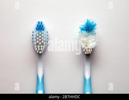 used and new toothbrush on a white background Stock Photo