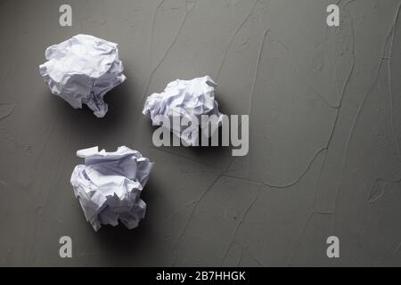 three crumpled sheets of paper on a concrete background with a place for your text Stock Photo