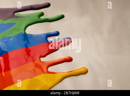 Colored paint stains dripping on gray background Stock Photo