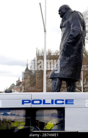 London, England, UK. Metropolitan police in a van parked beside the statue of Winston Churchill in Parliament Square, Westminster. Stock Photo