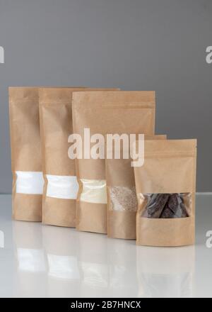 Download Brown Kraft Paper Doypack Bags With Groceries Front View On A Yellow Background Packaging For Foods And Goods Template Mock Up Packs With Windows Stock Photo Alamy Yellowimages Mockups
