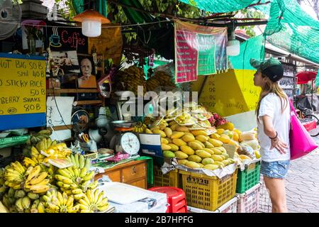 Thanon Khao San, Bangkok, Thailand - January 19, 2020 :  asian tourist woman looking and order mango sticky rice the famous traditional thai dessert f