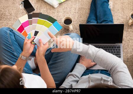 Unrecognizable couple choosing color for walls and furniture Stock Photo