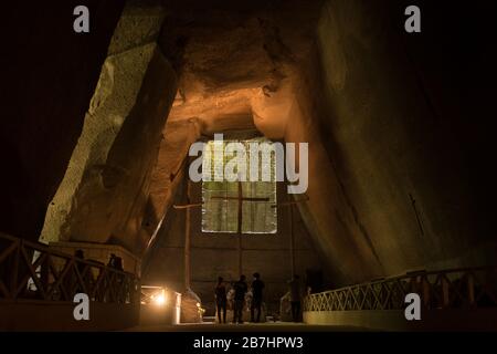 Three wooden crosses are seen at the end of a cave at the Cemetery of the Fontanelle in Naples, Italy Stock Photo