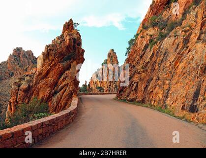 road called D81 in Corsica and the red rocks called Les Calanches Stock Photo
