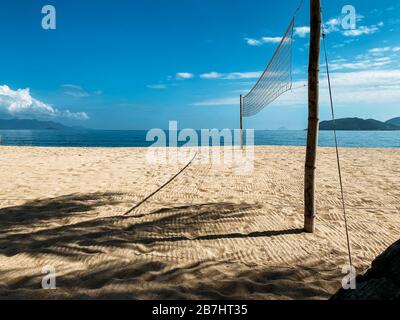 Beach volleyball court on the sandy shore near the sea. No one at the site. Sea view, sea waves, sunny day, windy weather Stock Photo