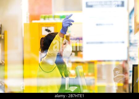 Gijon, Spain. 16th February, 2020. A shop assistant works with protection mask in a supermarket on February 16, 2020 in Gijon, Spain, after Spanish government approved Spain’s state of alarm decree to confine the whole country and reduce coronavirus infections. Coronavirus COVID-19 infections in Spain increase 1.000 in a day to reach 9.190, with more than 300 deaths. ©David Gato/Alamy Live News Stock Photo
