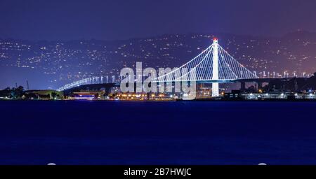 Panorama of the new span of the Bay Bridge from San Francisco to Oakland viewed from Marina District in San Francisco, California, USA. Long exposure Stock Photo