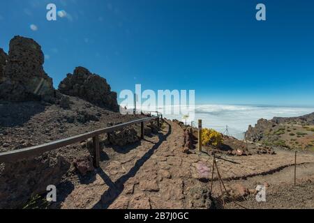 Above the clouds. Aerial view of the National Park Caldera de Taburiente, volcanic crater seen from mountain peak of Roque de los Muchachos Viewpoint. Stock Photo