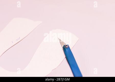 Leather craft or leather working. beautifully colored tanned leather on leather craftman's work desk with working tools. Stock Photo