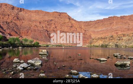 A Lone Angler Practicing Social Distancing Fly Fishing on the Colorado River at Lees Ferry recreation area in Arizona. Stock Photo