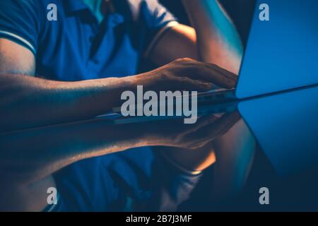 Remote Work Outsourcing. Caucasian Office Worker Doing His Job Right From His Home at Night. Stock Photo