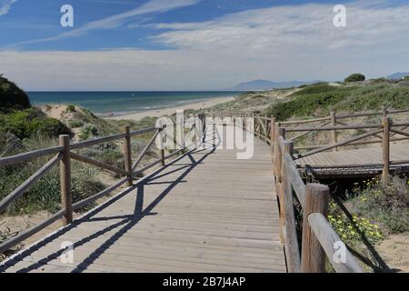 Wooden walkway at the natural park of Cabopino - Dunas de Artola, Marbella, Costa del Sol, Andalusia, Spain. Stock Photo
