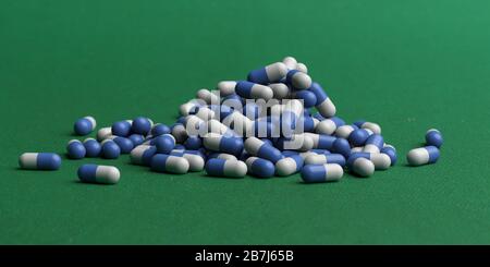 Capsule medicine pills, health pharmacy concept. Drugs for treatment medication. Heap of blue white color capsules on green background. 3d illustratio Stock Photo