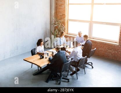 Multiracial Business Team Working Sitting At Desk In Office, High-Angle Stock Photo