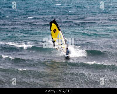 Windsurfing on the Mediterranean in Estepona, Costa del Sol, Spain on a glorious, windy, balmy sunny day in February. Spring had sprung. Stock Photo