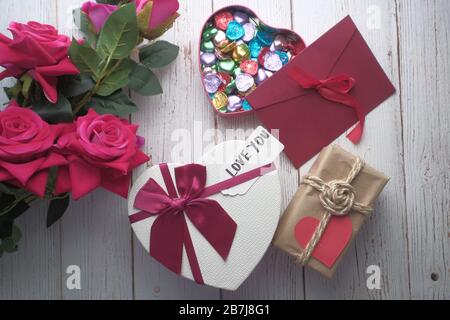 top view of heart shape gift box, rose candy envelope on table  Stock Photo