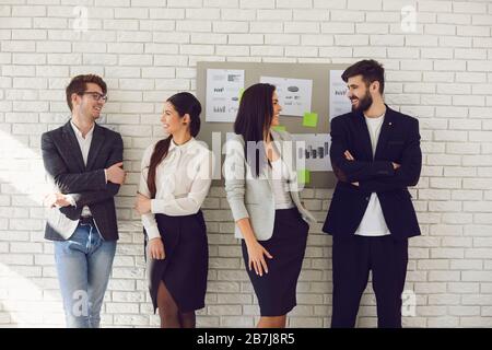 Group of young business people team standing teamwork are talking on the background. Stock Photo