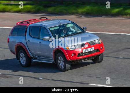 2006 grey red silver Mitsubishi L200 Elegance Di-D D/C A; UK vehicular traffic, transport, moving vehicles, LCV vehicle, roads, motors, motoring  4WD Pickup Truck on the M6 motorway highway Stock Photo