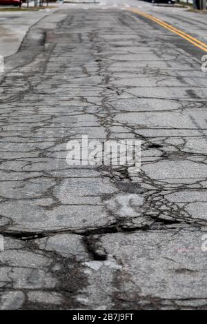 Cracked and damaged road surface. Stock Photo