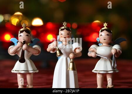 Advent Concert: three decoration angels making music in front of Advent wreath lights Stock Photo